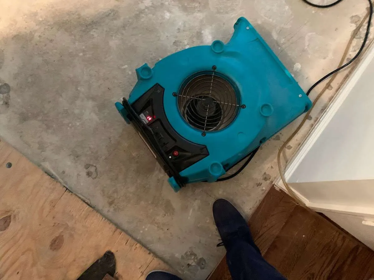 Air mover drying subfloor during Leak Detection & Repair in New Berlin